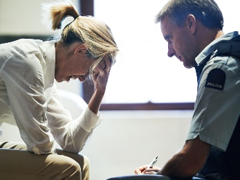 An upset woman and a police officer. 