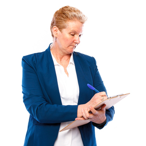 A woman writing on a clipboard. 