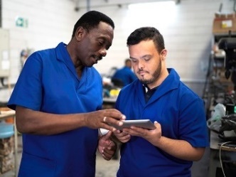 Two men reading an iPad.