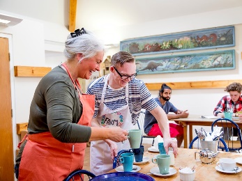 Two people working at a cafe. 