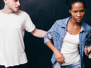 A man grabbing a woman. 