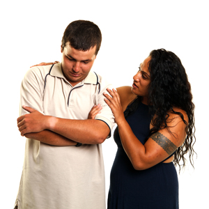 A woman supporting a man. 