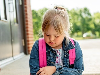 A young girl, who looks sad.