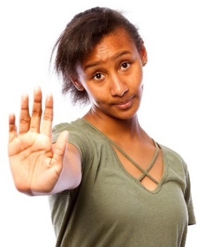 A person with their hand raised saying stop. 