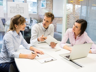 A group of people having a meeting about a document. 