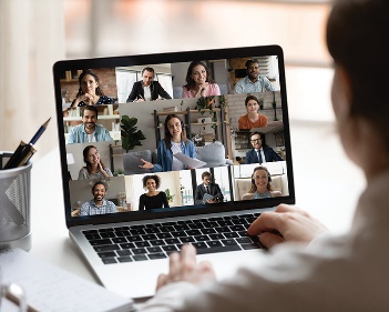 A person having a video call on their laptop. 