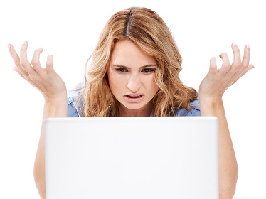 A person looking confused with their laptop open.