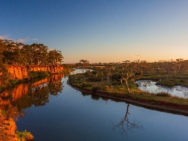 A photo of a river at sunset or sunrise.