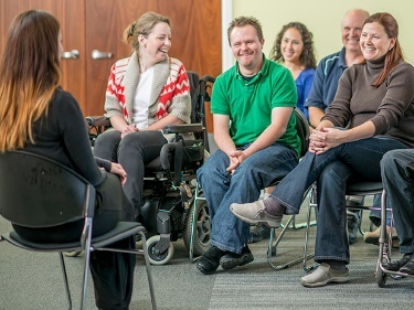 A person giving a talk to a small group of people. 