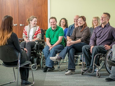 A person giving a talk to a small group of people. 