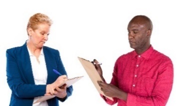 Two people writing in clipboards. 