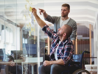 Two people working something out on a board. 