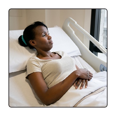 A person in a hospital bed. 