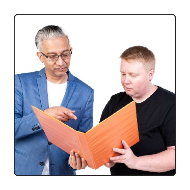A person supporting someone to read a document. 