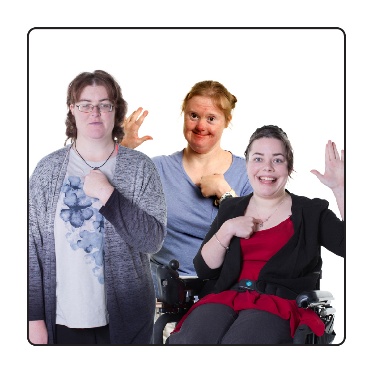 3 women pointing to themselves and raising their other hand. 