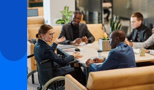 Women in wheelchair sitting at a table with other people