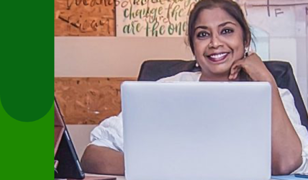Women sitting at desk with laptop open in front of her