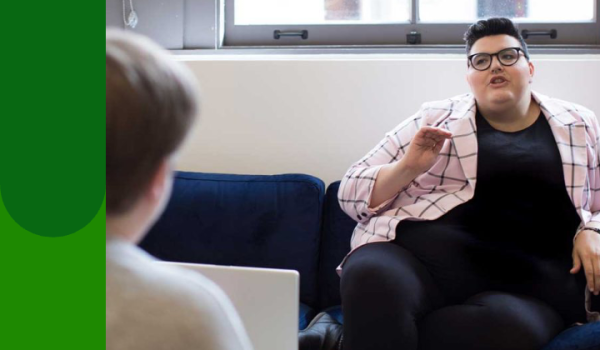 Woman on couch explaining something
