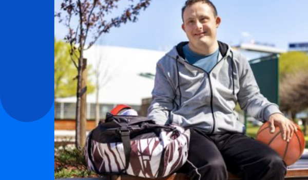 Man outside with sports bag and basketball