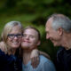 young man with down syndrome smiling with his family